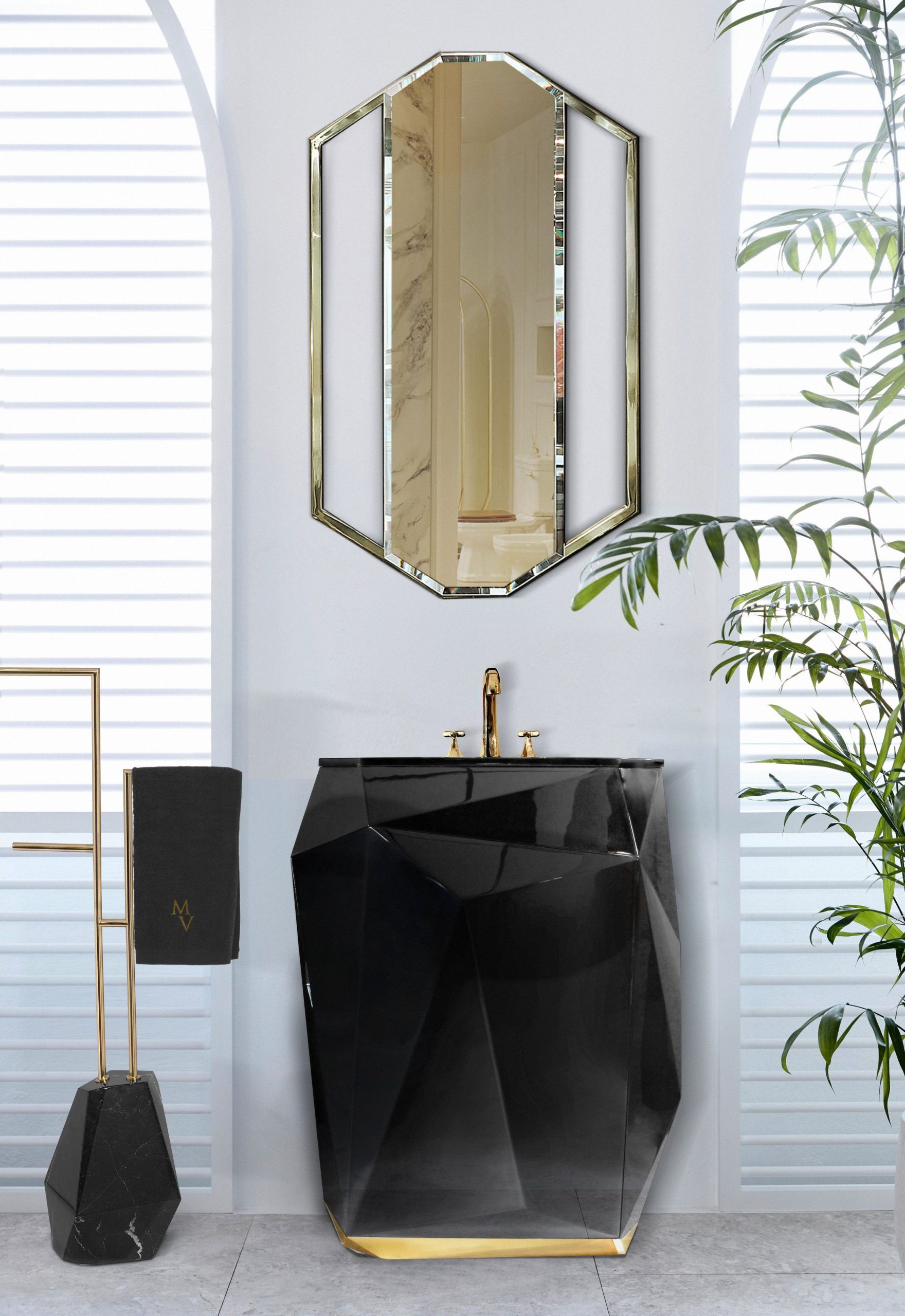 black diamond shaped freestanding with a gold mirror and a towel rack besides it
